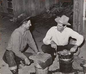 Image of Farmers freezing ice cream. Pie Town, New Mexico. There is no ice in the town. Two or three farmers have built ice storage houses of wooden blocks, packing the ice in sawdust. When someone makes the thirty or forty mile trip for ice, several families get 