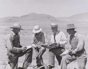Image of Mr. Thayne, FSA (Farm Security Administration) cooperative specialist, signing up three Ericson brothers to buy a cooperative tractor. Box Elder County, Utah