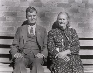 Image of Latter Day Saints portrait group. These people, man and wife, are both eigty-five years old. Converts to Mormonism from South Africa. She was the first schoolteacher in Escalante. They are dressed in their Sunday clothes