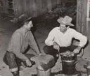 Image of Farmers freezing ice cream. Pie Town, New Mexico. There is no ice in the town. Two or three farmers have built ice storage houses of wooden blocks, packing the ice in sawdust. When someone makes the thirty or forty mile trip for ice, several families get 