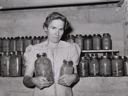 Image of Wife of Mormon farmer with canned goods. Snowville, Utah