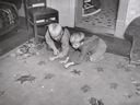 Image of Children of Mormon farmer playing marbles in the living room. Santa Clara, Utah